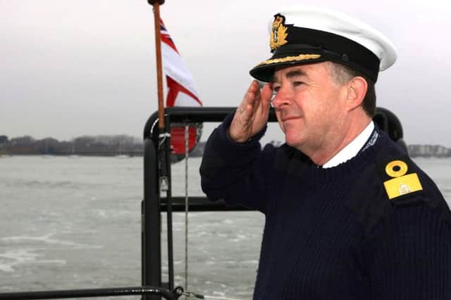 Cdre Jeremy Rigby saluting