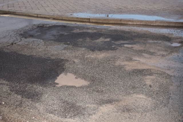 Tarmac has been damaged and repaired on the road exit to the bus terminal. Picture: Vernon Nash