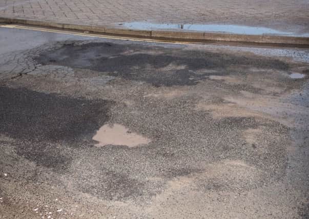 Tarmac has been damaged and repaired on the road exit to the bus terminal. Picture: Vernon Nash