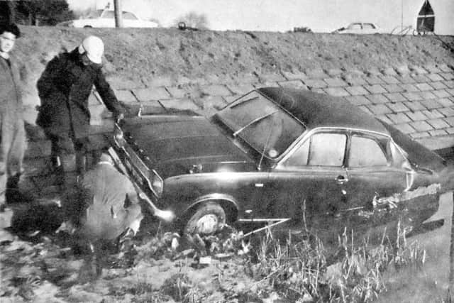 Breakdown workers preparing to haul out of the sea one of the cars involved in an accident on the Havant by-pass