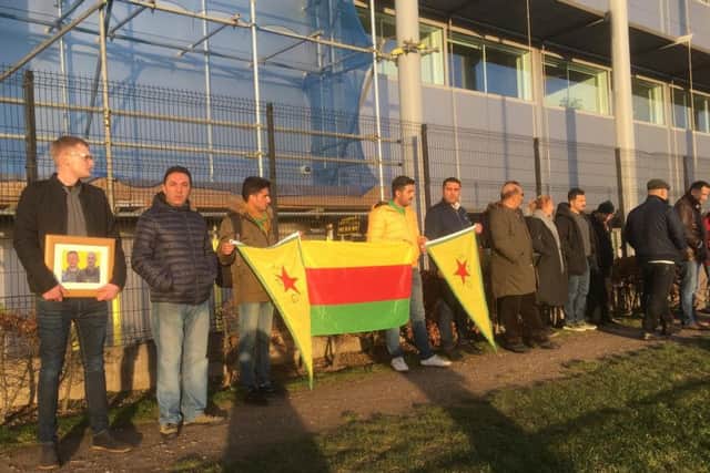 Members of the Kurdish community pay tribute to Ollie Hall as his body was repatriated via Heathrow Airport