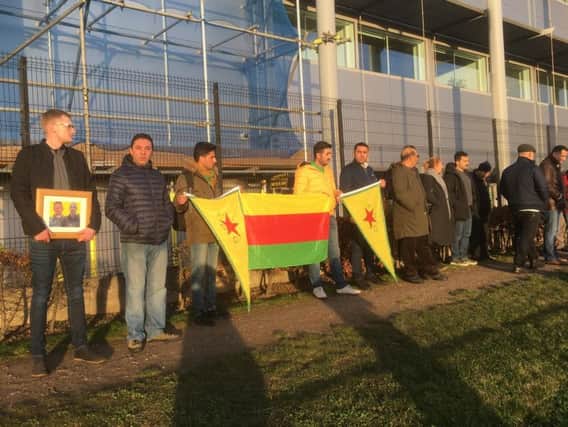 Members of the Kurdish community pay tribute to Ollie Hall as his body was repatriated via Heathrow Airport