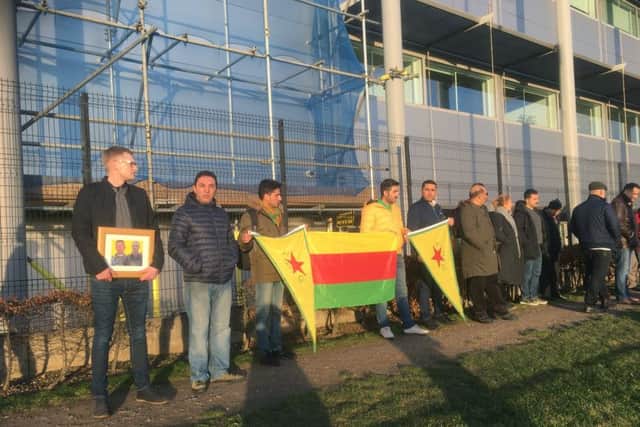 Members of the Kurdish community pay tribute to Ollie Hall as his body was repatriated via Heathrow Airport
