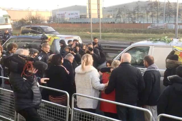 Members of the Kurdish community pay tribute to Ollie Hall as his body was repatriated via Heathrow Airport
