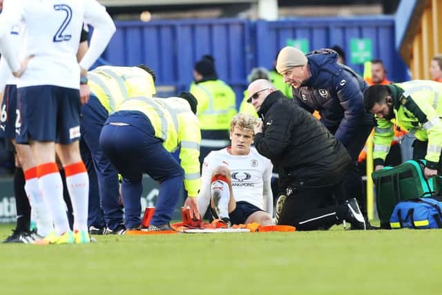 Cameron McGeehan was stretchered off for Luton last season at Pompey. Picture: Joe Pepler