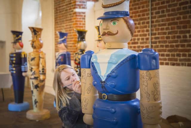 Wild in Art's Megan Evans working on Tales and Tattoos Nutcracker on Parade at the Historic Dockyard