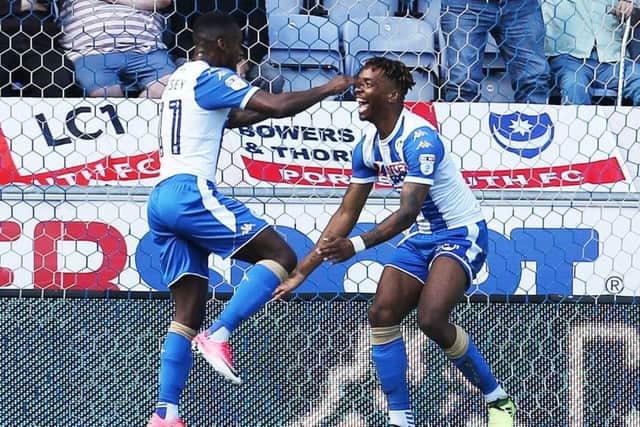 Ivan Toney, right, celebrates scoring for Wigan against Pompey earlier this season Picture: Joe Pepler