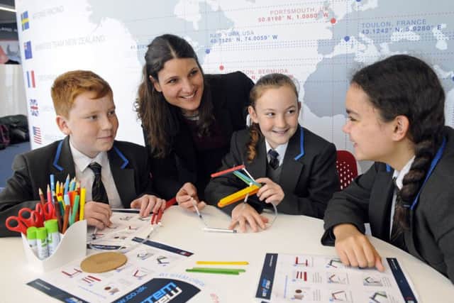 Amelia Gould, Head of Engineering at BAE Systems, Naval Ships, Combat Sytems with Year 7 students from Carisbrooke College on The Isle of Wight at Land Rover BAR. From left: Sam I'Anson, Elissa Gildart and Laila Elias     Picture: Malcolm Wells (180116-3654)