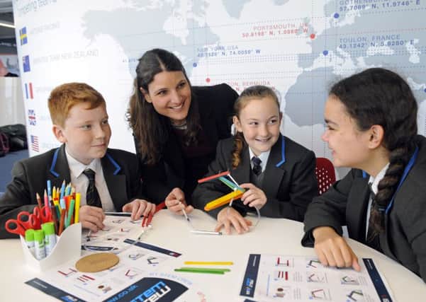 Amelia Gould, Head of Engineering at BAE Systems, Naval Ships, Combat Sytems with Year 7 students from Carisbrooke College on The Isle of Wight at Land Rover BAR. From left: Sam I'Anson, Elissa Gildart and Laila Elias     

Picture: Malcolm Wells (180116-3654)