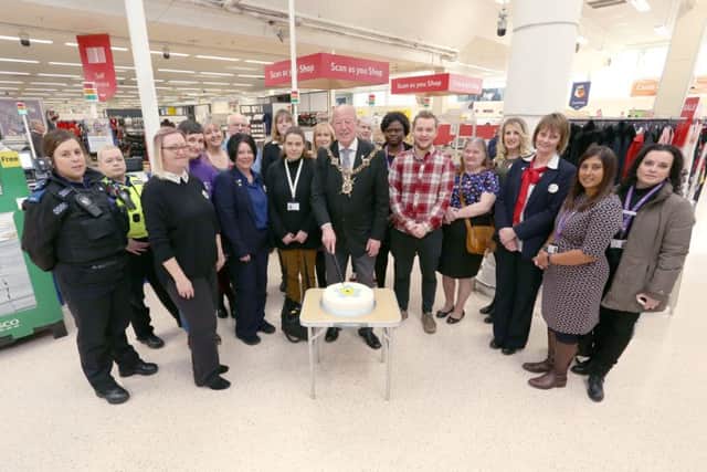 The Lord Mayor of Portsmouth, Cllr Ken Ellcome, cuts a cake accompanied by Tesco staff, members of Solent Mind and other local organisations as Tesco at North Harbour joined the Dementia Action Alliance. Picture: Habibur Rahman