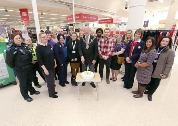 The Lord Mayor of Portsmouth, Cllr Ken Ellcome, cuts a cake accompanied by Tesco staff, members of Solent Mind and other local organisations as Tesco at North Harbour joined the Dementia Action Alliance. Picture: Habibur Rahman