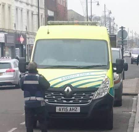 A ticket officer issuing a parking ticket to an ambulance in West Street, Fareham. Picture: Ben Trickett