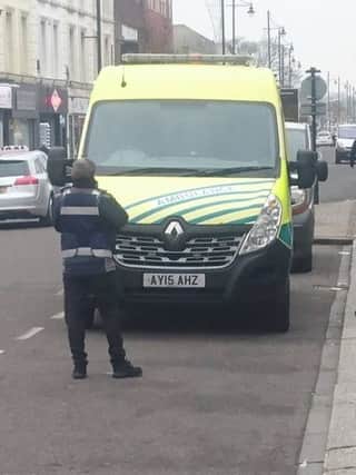 A ticket officer issuing a parking ticket to an ambulance in West Street, Fareham. Picture: Ben Trickett