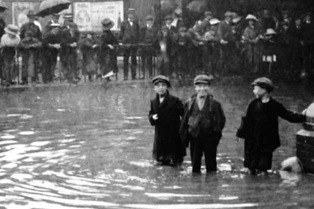 The boys face in the centre says it all. Flooding in Commercial Road taken from inside the gates of the railway goods shed.  bbbb