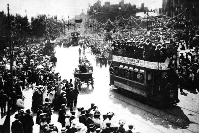 Thousands line the streets of Portsmouth to cheer French matelots in a convoy of tramcars.