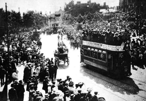 Thousands line the streets of Portsmouth to cheer French matelots in a convoy of tramcars.