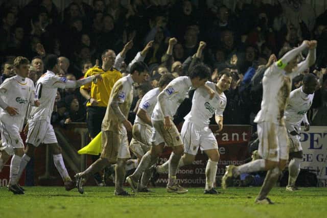 Hawks players celebrate beating Swansea to earn a trip to Anfield