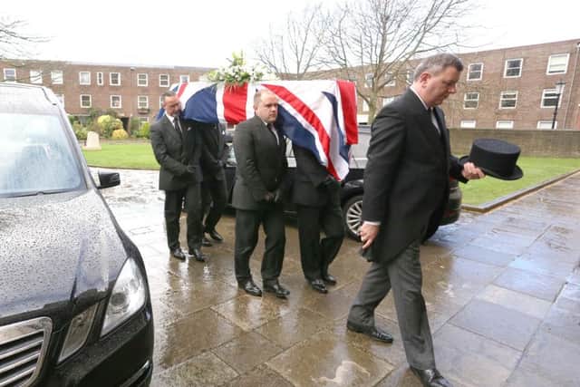 Canon Roger Devonshire's coffin is carried in to Portsmouth Cathedral