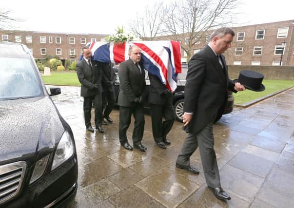 Canon Roger Devonshire's coffin is carried in to Portsmouth Cathedral