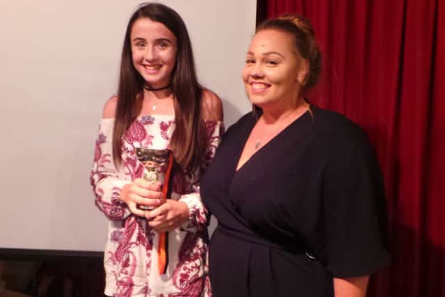 Charlotte Ward presents Caitlin Roberts, left, with the coach's player of the year trophy at the Fireflys' annual awards night