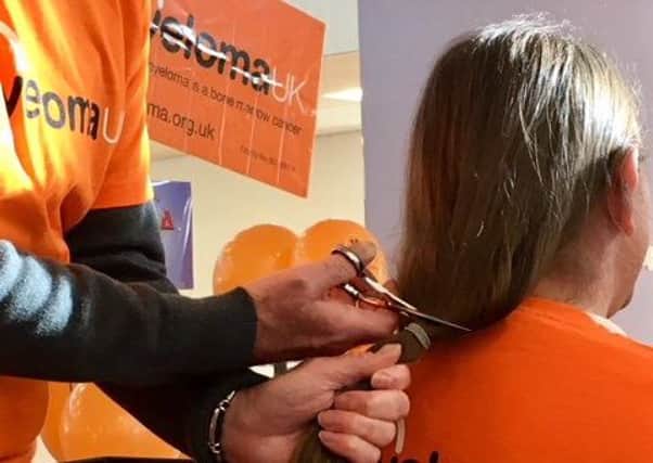 Steve Gaiger getting his ponytail cut off