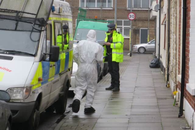 Police officers, including a forensic investigator, at the scene of the murder in Toronto Road, Buckland