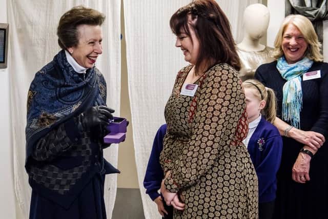 Making Space designer Isobel Haly,16, presents the Princess Royal with a hand-crafted tin brooch. Credit: Tom Langford