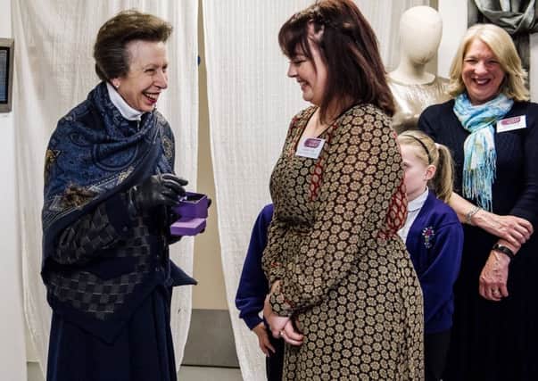 Making Space designer Isobel Haly,16, presents the Princess Royal with a hand-crafted tin brooch. Credit: Tom Langford