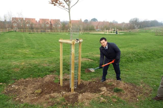 Havant MP Alan Mak plants a tree at the Hampshire Farm Meadows near Emsworth