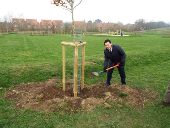 Havant MP Alan Mak plants a tree at the Hampshire Farm Meadows near Emsworth