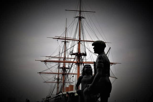 NEAL TUFFS The Portsea mudlark statue in front of HMS Warrior