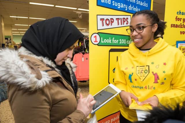Shukrya Saida signs up for further information and vouchers, helped by Shona Green. Picture: Vernon Nash