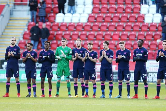 Christian Burgess, left, and the Pompey squad pay their respects to Cyrille Regis before Saturday's clash at Rotherham. Picture: Joe Pepler