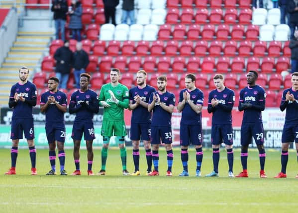 Christian Burgess, left, and the Pompey squad pay their respects to Cyrille Regis before Saturday's clash at Rotherham. Picture: Joe Pepler