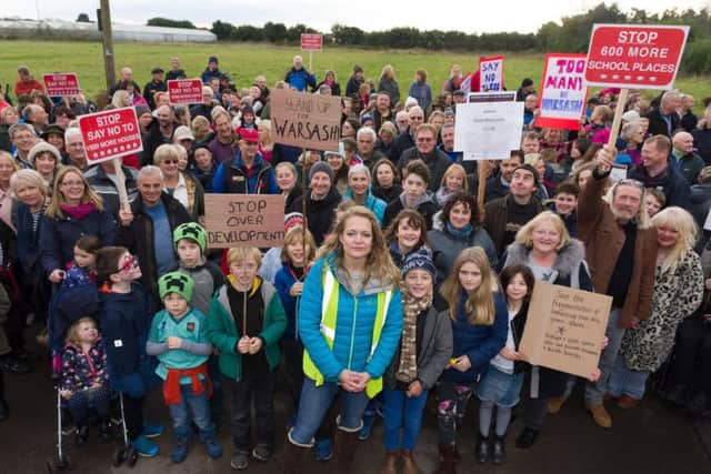 Members of a group which started on Facebook called Save Warsash are pictured protesting against Fareham Borough Council's plans to build 800 homes in the area. Protest organiser Rachel Follett is centre front