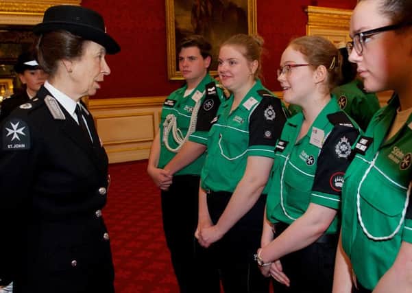 The Princess Royal talks to Samantha Cooper, third left, at a reception at St James' Palace