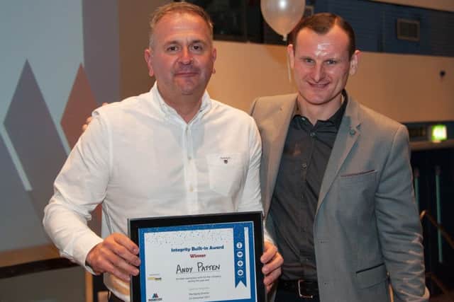 Andy Patten collects his award