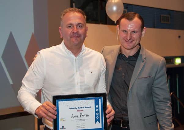 Andy Patten collects his award