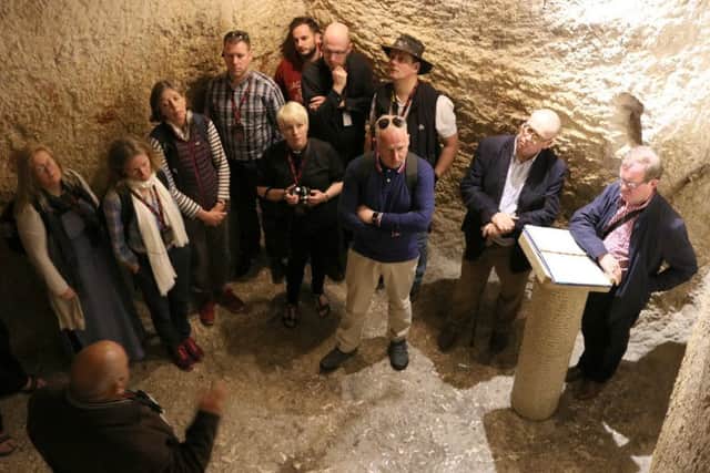 Bishop Christopher Foster leads a reflection inside the dungeon under the High Priests house, where Jesus would have been held