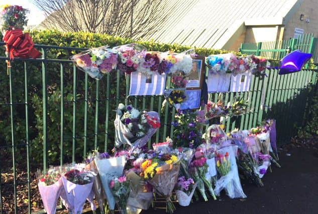 Floral tributes to Helen Lloyd outside Henry Cort Community College