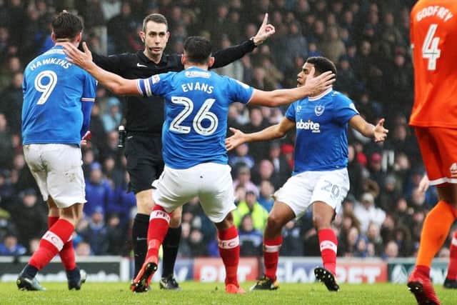 Referee David Coote is confronted by Oli Hawkins, Gareth Evans and Nathan Thompson after turning down a first-half penalty. Picture: Joe Pepler
