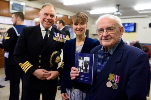 Denis Cole, 94, at the launch  of his new book - a naval wartime memoir. He is joined by Captain Bill Oliphant, left, and Christine Mustchin at the The Cockleshell Naval Community Centre, Eastney         Picture: Duncan Shepherd (180088_003)