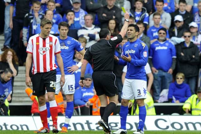 Richardo Rocha is booked by referee Neil Swarbrick. Picture: Allan Hutchings (121221-711)