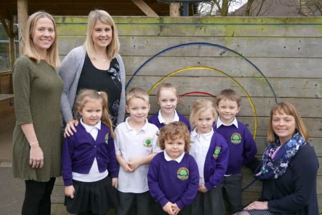 Padnell Infant school headteacher Mandy Grayson, right, deputy headteacher Lara
Tripp, left, and Emma Smile, second left, with children