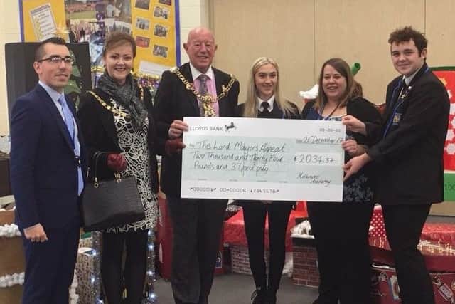 Lord Mayor Cllr Ken Ellcome and Lady Mayoress Jo Ellcome receiving a cheque from Miltoncross Academy pupils and staff