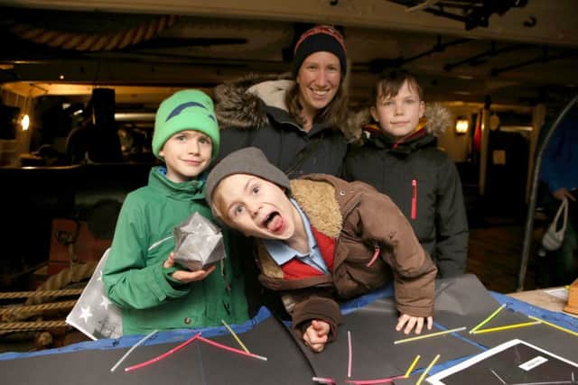 Gemma McEwen with her children, Rory, nine, Felix, five, and Harry, 11, making star constellations on board of HMS Warrior   (180164-520)