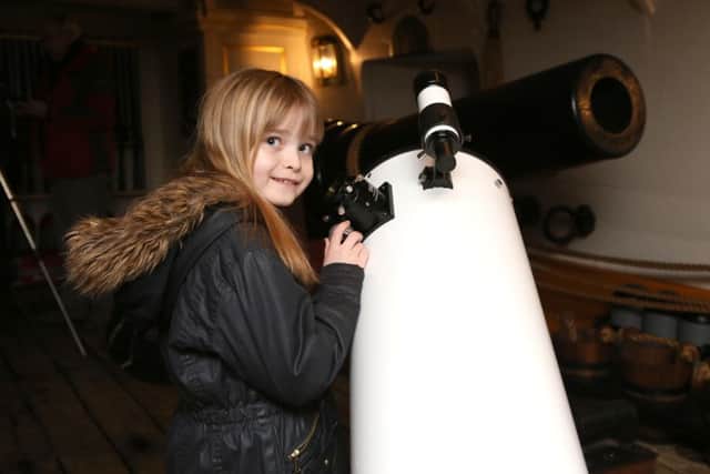 Nevaeh Dunmore-Simlins, eight, next to a Dobsonian Relfector Telescope    (180164-522)