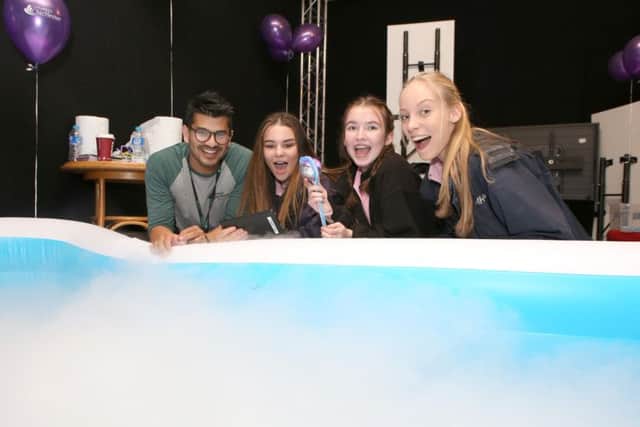 Ali Khan from the University of Chichester with Amelia King 15, Ivy Pope 15 and Tara Holland 15 learning about boat engineering in a dry ice-filled inflatable pool  (IMG_6482)