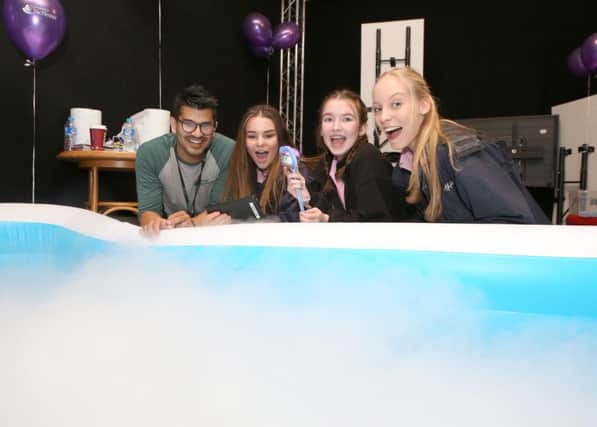 Ali Khan from the University of Chichester with Amelia King 15, Ivy Pope 15 and Tara Holland 15 learning about boat engineering in a dry ice-filled inflatable pool  (IMG_6482)