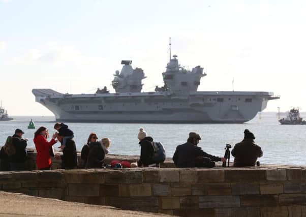HMS Queen Elizabeth draws a crowd at the waterfront as she sets sail. 

Picture: Habibur Rahman
